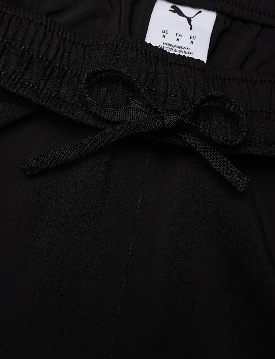 Close-up of fabric and logo on PUMA 2071451 Training Shorts, showing woven texture and brand patch.