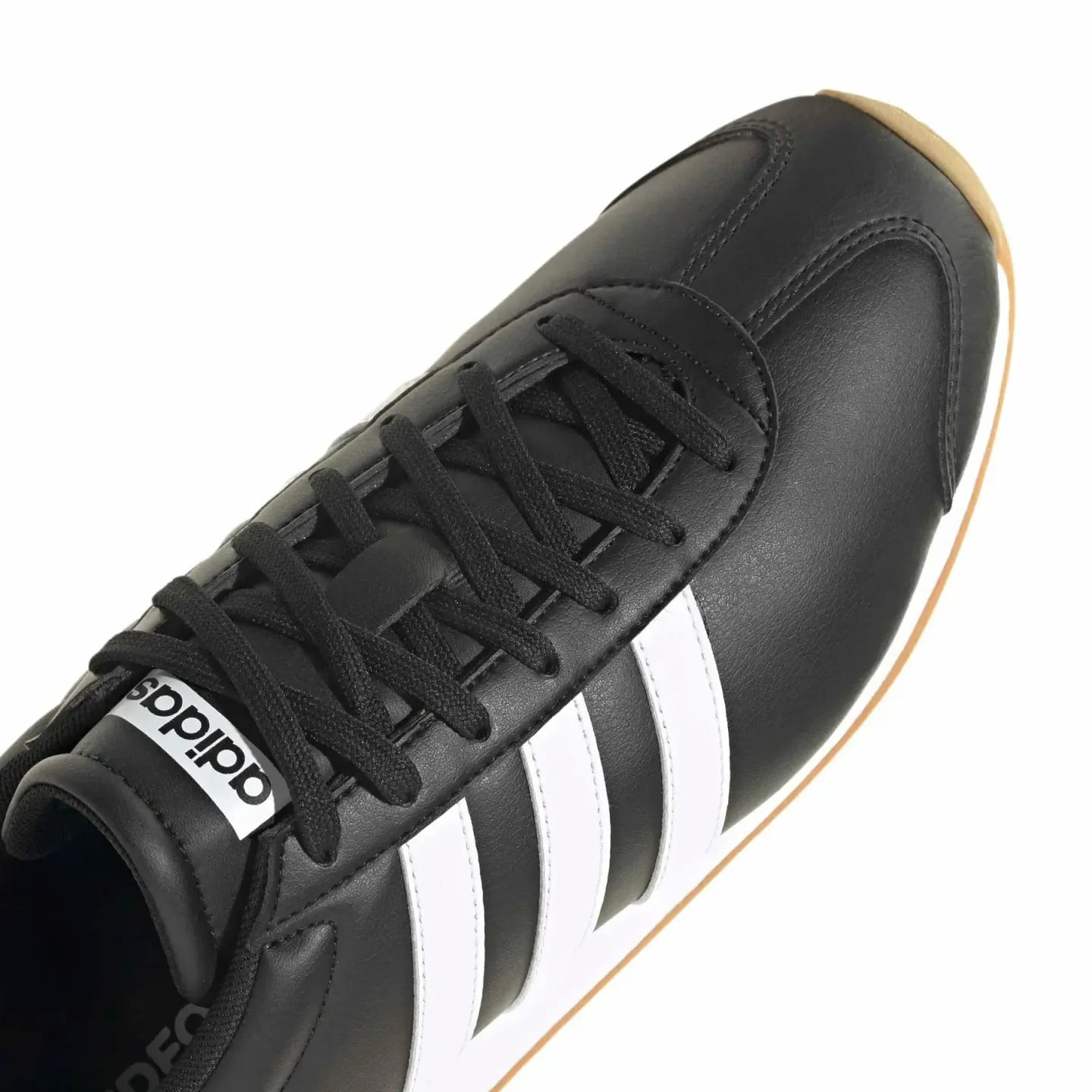 Gros plan des lacets de la basket adidas Runvista noire, détails des 3 bandes blanches et surpiqûres