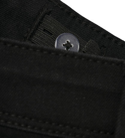 Close-up of the adjustable inner elastic waistband and button on NAME IT NKFPOLLY jeans