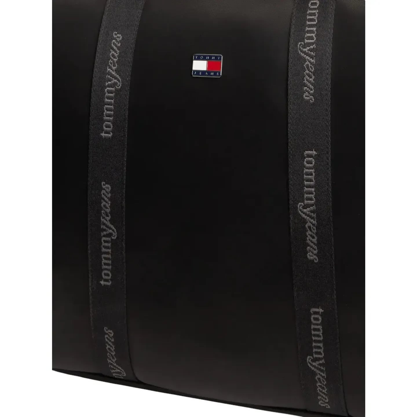 Gros plan sur le patch drapeau Tommy Jeans et les anses logo du sac tote noir