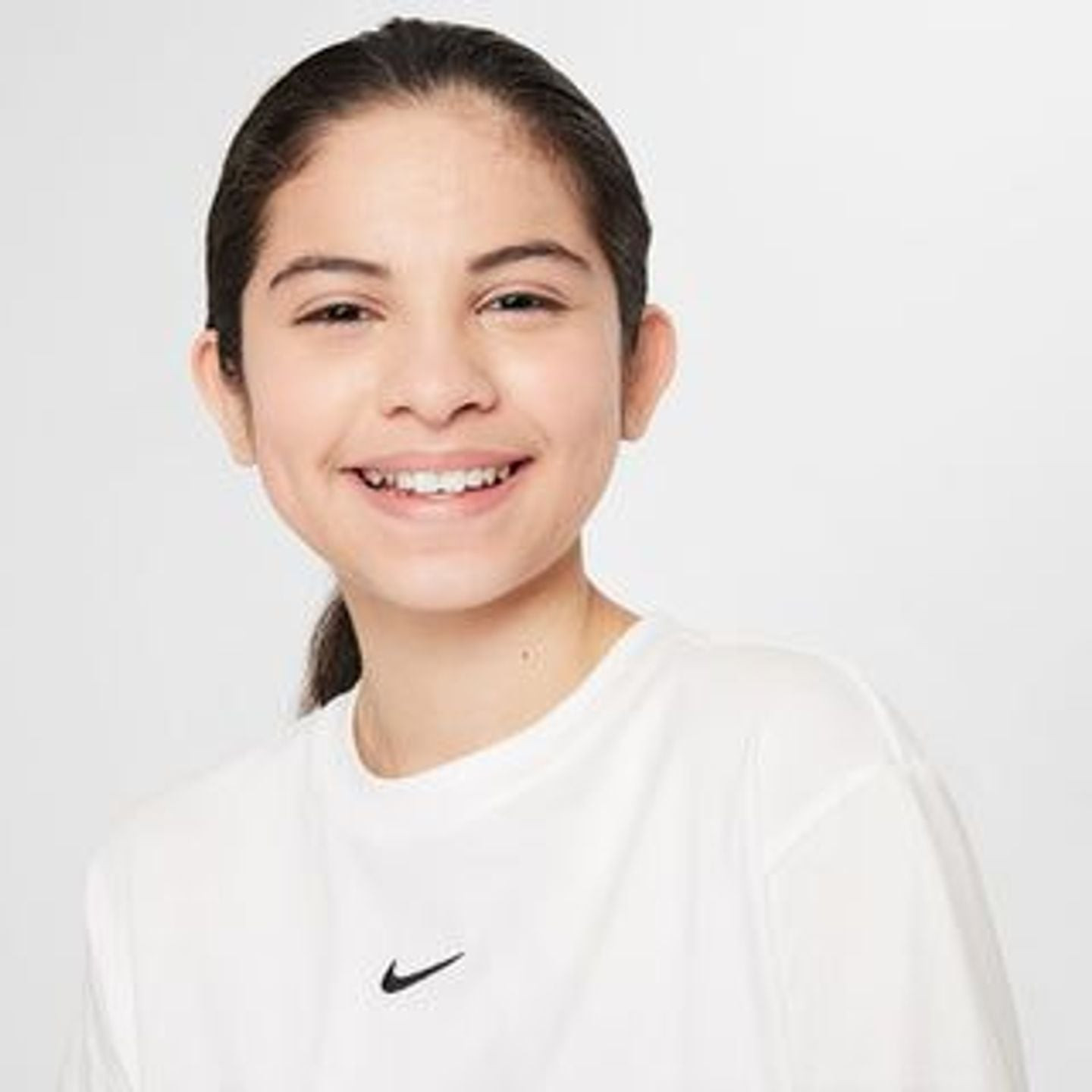 Jeune fille portant le Nike T-Shirt Manches Courtes Coupe Boxy Sportswear Essential Junior Fille en 