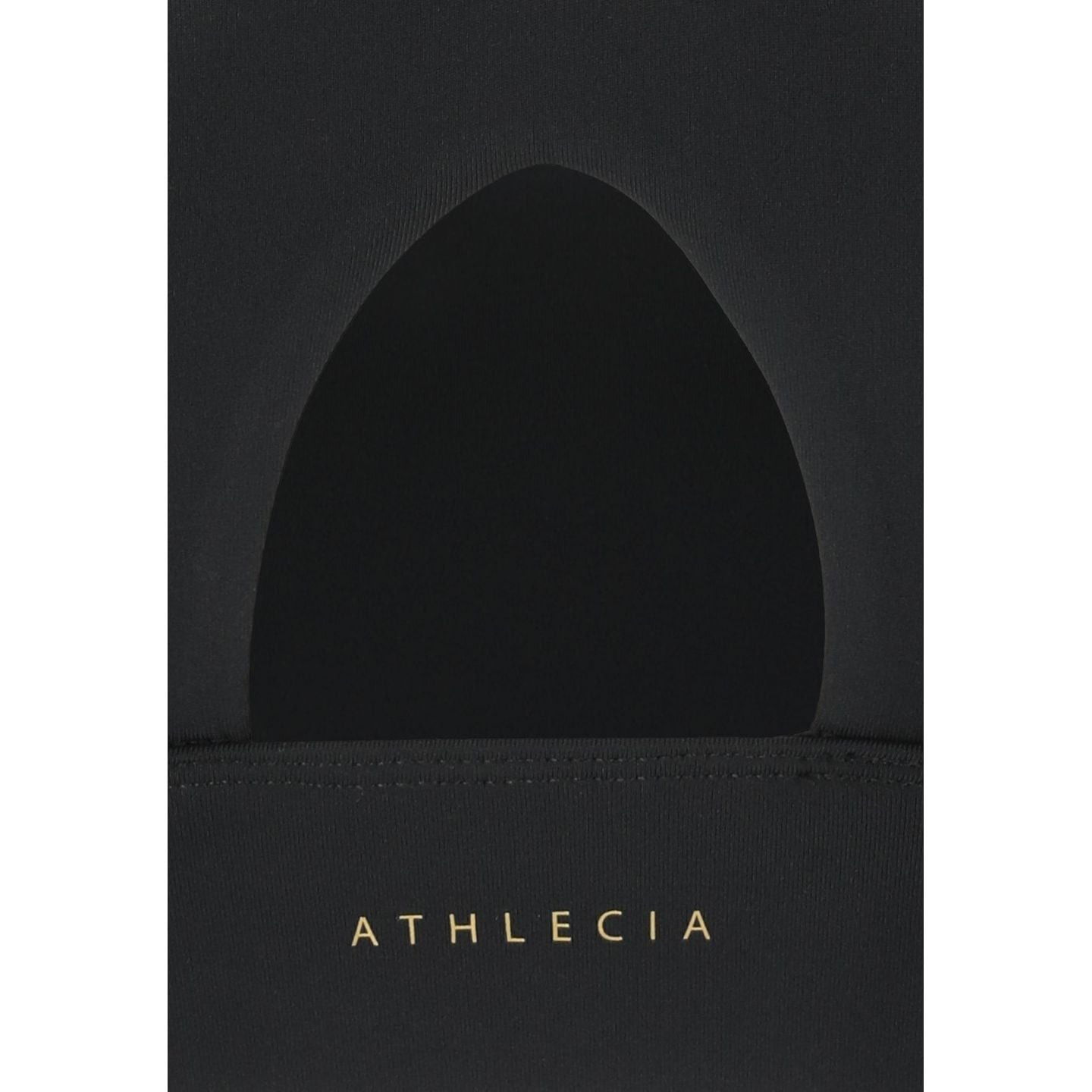 Gros plan de la découpe dorsale de la brassière de sport DIRENNA noire, logo Athlecia doré sur la ba