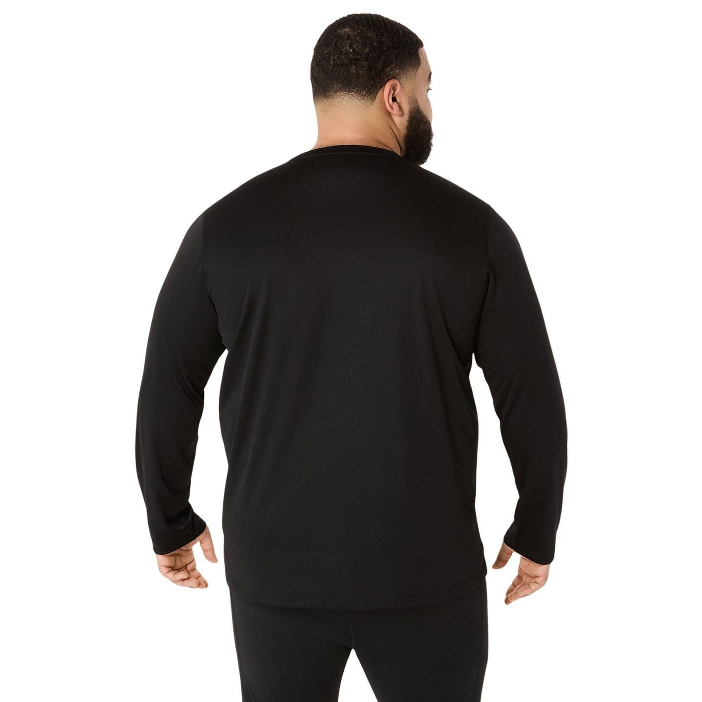 Coureur portant l'ASICS Haut De Running Manches Longues Core LS Top Homme en extérieur.